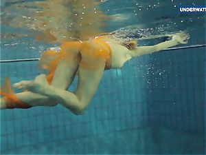 Yellow and red clad teenager underwater